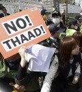 Protesters struggle with police officers as they march toward the Defense Ministry during a rally against the visit by U.S. Defense Secretary Ash Carter in Seoul, South Korea, Friday, April 10, 2015. Protesters opposed a possible deployment of a Terminal High-Altitude Area Defense (THAAD) system on Korea Peninsula. (AP Photo/Ahn Young-joon)