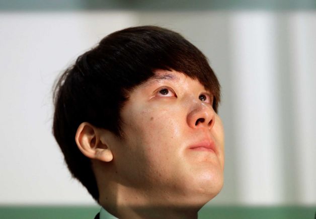 Former Olympic swimming champion Park Tae-hwan of South Korea holds back tears during a news conference in Seoul, South Korea. Former Olympic swimming champion Park Tae-hwan of South Korea offered a public apology Friday, four days after receiving an 18-month ban for failing a doping test. (AP Photo/Lee Jin-man)