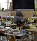 In this picture taken on Wednesday, April 8, 2015, an alumna sits in a victim's chair inside a classroom at Danwon High School in Ansan, south of Seoul, South Korea. One year ago the ferry Sewol carrying 325 second-year students on a field trip to a southern island sank; only 75 survived. Their classrooms in this city about an hour south of Seoul have barely changed from the day they left for the trip. (AP Photo/Lee Jin-man)