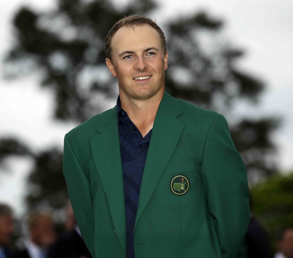 Jordan Spieth poses with his green jacket after winning the Masters golf tournament Sunday, April 12, 2015, in Augusta, Ga. (AP Photo/David J. Phillip)