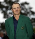 Jordan Spieth poses with his green jacket after winning the Masters golf tournament Sunday, April 12, 2015, in Augusta, Ga. (AP Photo/David J. Phillip)