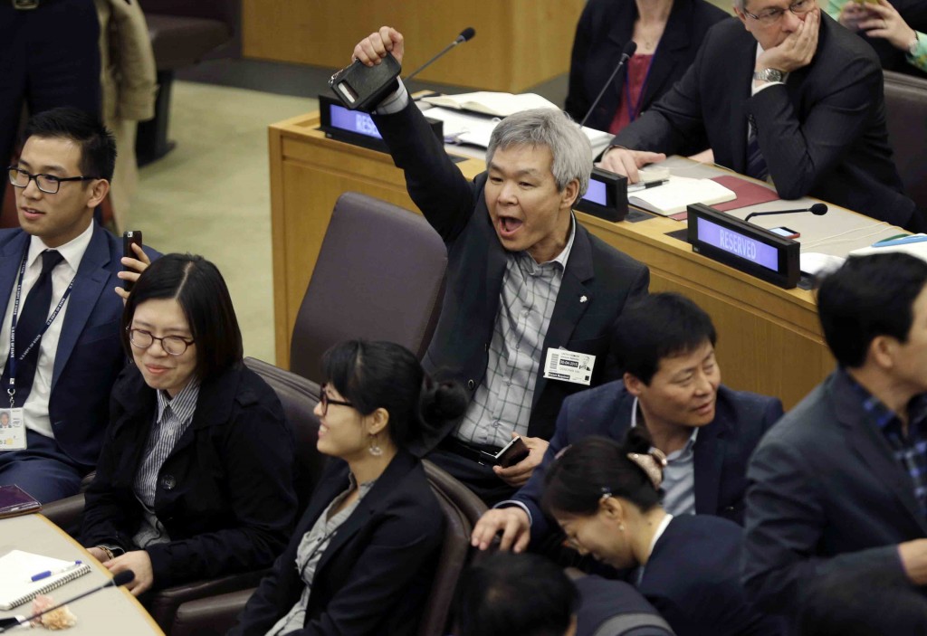 A North Korean defector, center, yells to try and drown out a statement being read by North Korean diplomats during a panel on North Korean human rights abuses, at United Nations headquarters, Thursday, April 30, 2015. (AP Photo/Seth Wenig)