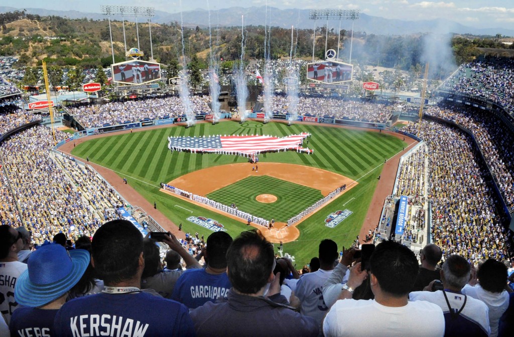Fans cheer during Opening Day ceremonies, that includes members of the U.S. military holding a flag in the shape of the United States, before the San Diego Padres face the Los Angeles Dodgers in a baseball game at Dodger Stadium in Los Angeles, Monday, April 6, 2015. (Park Sang-hyuk / The Korea Times)