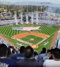 Fans cheer during Opening Day ceremonies, that includes members of the U.S. military holding a flag in the shape of the United States, before the San Diego Padres face the Los Angeles Dodgers in a baseball game at Dodger Stadium in Los Angeles, Monday, April 6, 2015. (Park Sang-hyuk / The Korea Times)