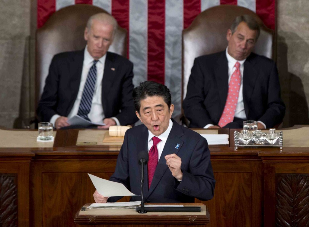 Japanese Prime Minister Shinzo Abe speaks before a joint meeting of Congress, Wednesday, April 29, 2015, on Capitol Hill in Washington. Vice President Joe Biden, left, and House Speaker John Boehner of Ohio listen. (AP Photo/Carolyn Kaster)