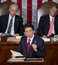 Japanese Prime Minister Shinzo Abe speaks before a joint meeting of Congress, Wednesday, April 29, 2015, on Capitol Hill in Washington. Vice President Joe Biden, left, and House Speaker John Boehner of Ohio listen. (AP Photo/Carolyn Kaster)