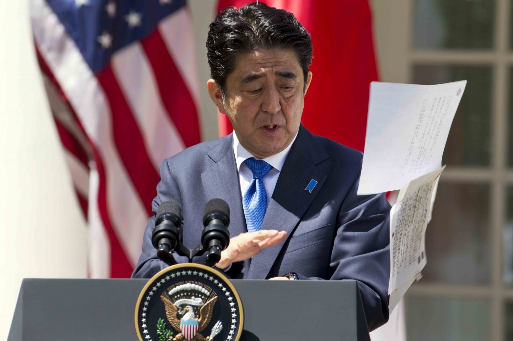 Japanese Prime Minister Shinzo Abe reacts as his papers are blown into the air in a gust of wind during his joint news conference with President Barack Obama, Tuesday, April 28, 2015, in the Rose Garden of the White House in Washington. (AP Photo/Jacquelyn Martin)