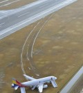 An Asiana Airlines plane sits at Hiroshima airport in Mihara, Hiroshima prefecture, western Japan Wednesday, April 15, 2015 after it skidded off a runway Tuesday. About 20 people received minor injuries, officials said. (Muneyuki Tomari/Kyodo News via AP)