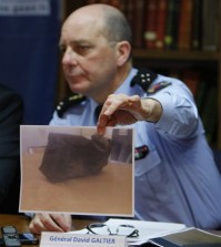 General David Galtier displays a picture showing the second black box from the Germanwings plane that crashed in the French Alps last week, during a press conference in Marseille, southern France, Thursday, April 2, 2015. Brice Robin announced that a gendarme found the second black box flight recorder of Germanwings Flight 9525, blackened and buried in the soil of the Alps, and investigators hope to be able to analyse its data for more clues to what happened. (AP Photo/Claude Paris)