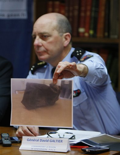 General David Galtier displays a picture showing the second black box from the Germanwings plane that crashed in the French Alps last week, during a press conference in Marseille, southern France, Thursday, April 2, 2015. Brice Robin announced that a gendarme found the second black box flight recorder of Germanwings Flight 9525, blackened and buried in the soil of the Alps, and investigators hope to be able to analyse its data for more clues to what happened. (AP Photo/Claude Paris)