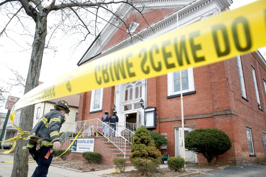 Firefighters go back into the church to check on its condition. The roof of the Korean Union United Methodist Church collapsed during services for the Manantial De Vida Church, Sunday, April 5, 2015, in Rahway, NJ. One person was seriously injured; about a dozen others had minor injuries. The injured people reportedly were members of a separate congregation that rents out space at the church. None of the injuries were considered life-threatening. (AP Photo/The Star-Ledger, Aristide Economopoulos)