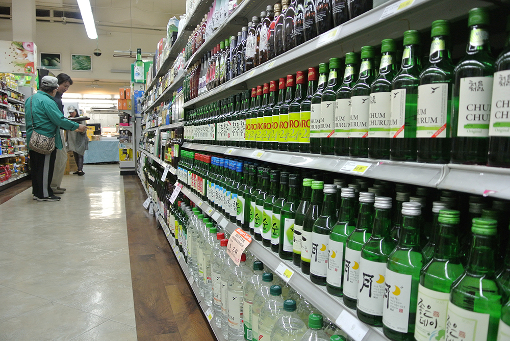 Bottles of soju line shelves at a Los Angeles Korean market.