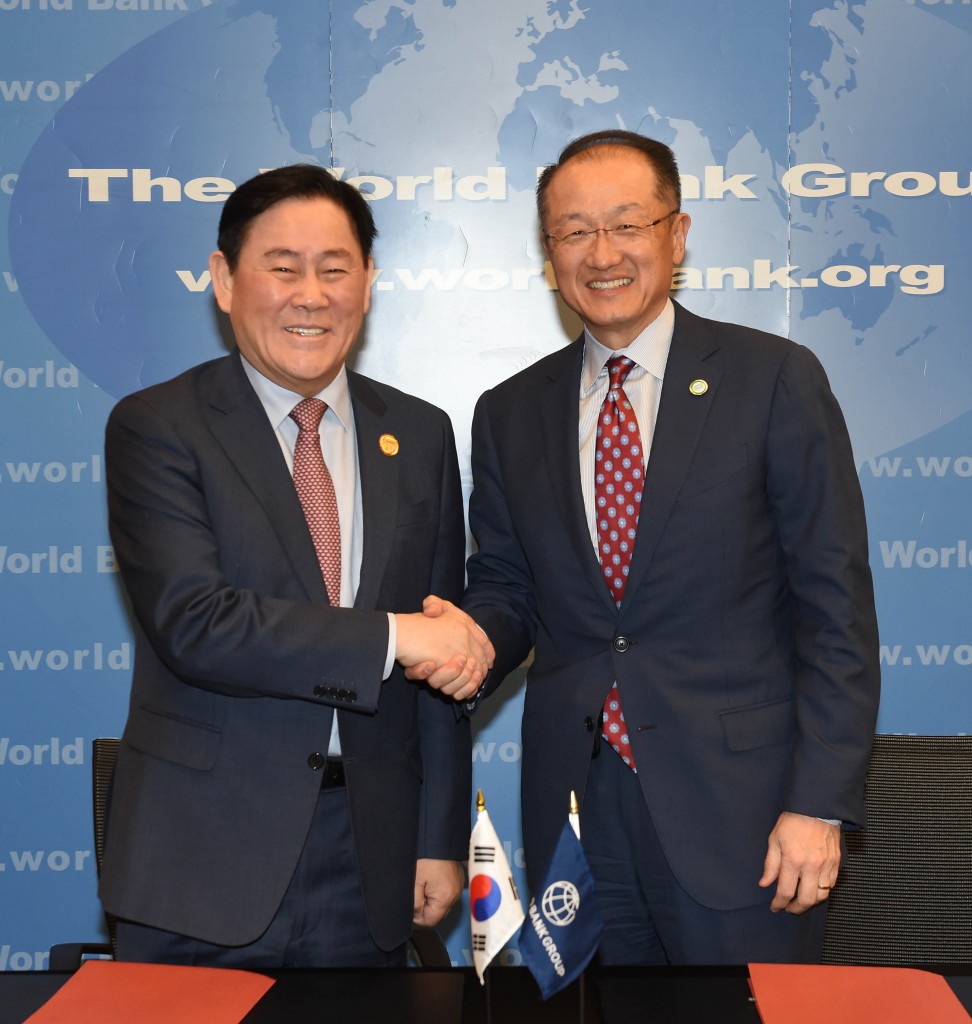 Finance Minister Choi Kyung-whan (L) and World Bank chief Jim Yong Kim poses for photo after signing an MOU outlining South Korea's support for infrastructure building in the developing world in Washington on April 15, 2015. (NEWSis)