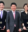 Woosuk University named Thailand taekwondo director Choi Young-seok, left, and K-pop star Kahi, right, as visiting professors of the school's taekwondo department Thursday. (Yonhap)