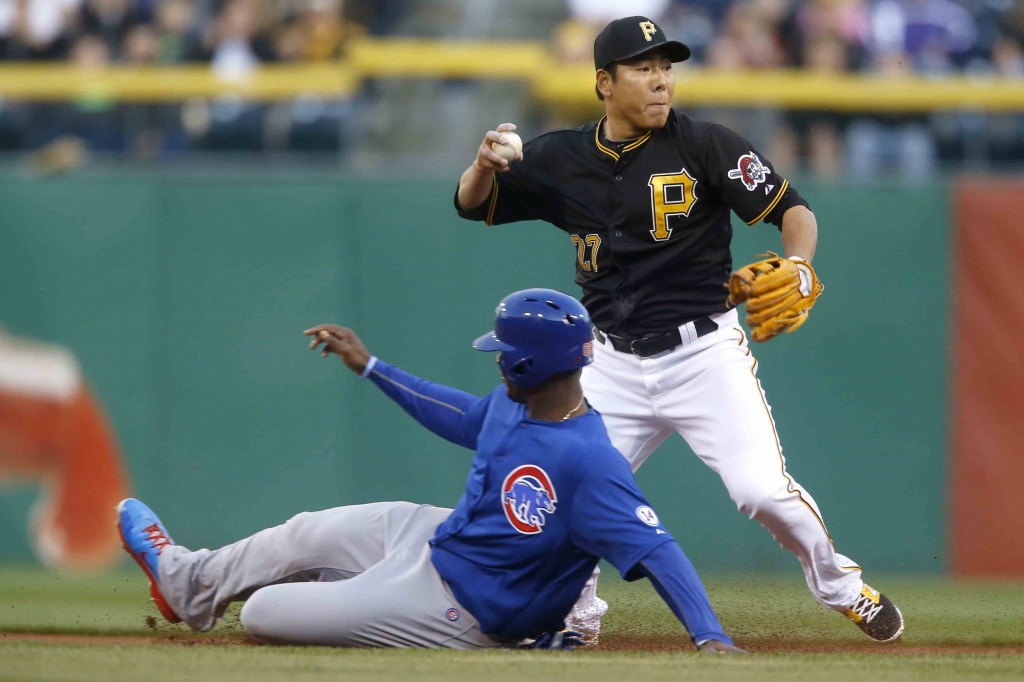 Pittsburgh Pirates shortstop Jung Ho Kang, top, throws to first as Chicago Cubs' Jorge Soler is out at second on a fielders choice on a ground ball by Anthony Rizzo in the first inning of a baseball game on Monday, April 20, 2015, in Pittsburgh. (AP Photo/Keith Srakocic)