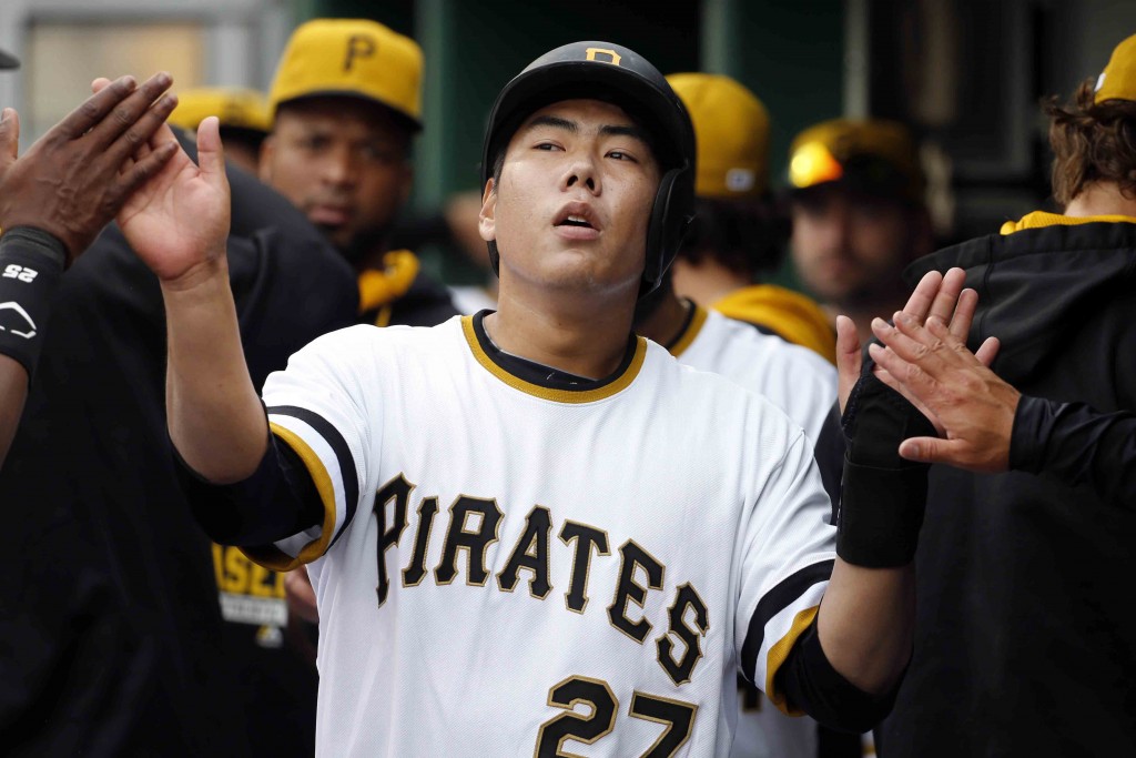 Pittsburgh Pirates' Jung Ho Kang of Korea (27) celebrates in the dugout after scoring on a two-run single by Chris Stewart in the during the sixth inning of a baseball game against the Milwaukee Brewers in Pittsburgh, Sunday, April 19, 2015. (AP Photo/Gene J. Puskar)