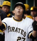 Pittsburgh Pirates' Jung Ho Kang of Korea (27) celebrates in the dugout after scoring on a two-run single by Chris Stewart in the during the sixth inning of a baseball game against the Milwaukee Brewers in Pittsburgh, Sunday, April 19, 2015. (AP Photo/Gene J. Puskar)