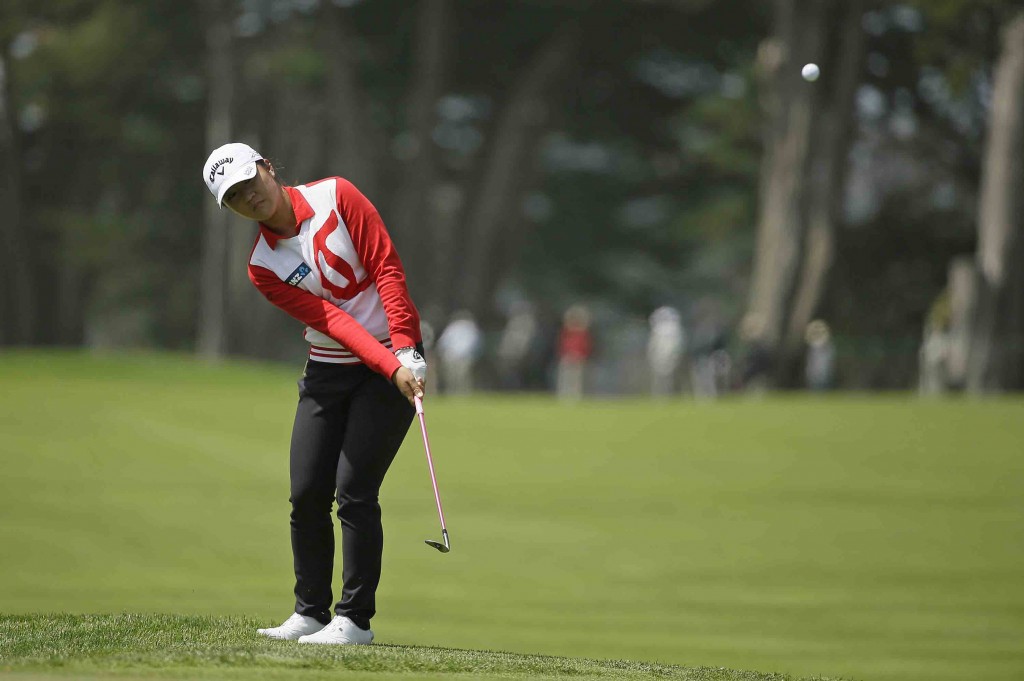 Lydia Ko of New Zealand chips the ball up to the sixth green of the Lake Merced Golf Club during the first round of the Swinging Skirts LPGA Classic golf tournament Thursday, April 23, 2015, in Daly City, Calif. (AP Photo/Eric Risberg)