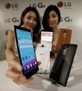 Models pose with LG Electronics' new G4 smartphones during its unveiling ceremony in Seoul, South Korea Wednesday, April 29, 2015. LG Electronics Inc. says its quarterly profit plunged 59 percent from a year earlier as losses from TVs offset a modest improvement in its smartphone business. (AP Photo/Ahn Young-joon)