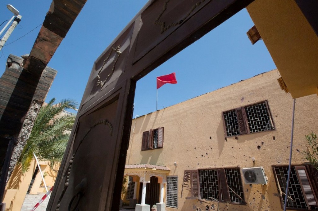 A flag flies over the Moroccan Embassy after a bomb placed in a garbage bin targeted the site in the capital, Tripoli. in Tripoli, Libya on Monday, April 13, 2015. There were no casualties in the attack, which was claimed by Libya's Islamic State affiliate. (AP Photo/Mohamed Ben Khalifa)