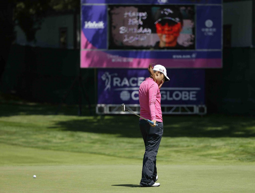 Lydia Ko, of New Zealand, reacts after missing a birdie putt on the ninth green of the Lake Merced Golf Club as a sign in the background wishes her a happy 18th birthday during the second round of the Swinging Skirts LPGA Classic golf tournament Friday, April 24, 2015, in Daly City, Calif. (AP Photo/Eric Risberg)