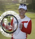 Lydia Ko of New Zealand poses for a photo with her trophy after winning the Swinging Skirts LPGA Classic golf tournament Sunday, April 26, 2015, in Daly City, Calif. Ko won the tournament for the second straight year, beating Morgan Pressel on the second hole of a playoff. (AP Photo/Eric Risberg)