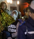 A migrant is helped disembark in the Sicilian harbor of Pozzallo, Italy, early Monday, April 20, 2015. About 100 migrants, including 28 children, were rescued on Sunday by a merchant vessel in the Sicilian Strait while they were trying to cross. Another smuggler's boat crammed with hundreds of people overturned off Libya's coast on Saturday as rescuers approached, causing what could be the Mediterranean's deadliest known migrant tragedy and intensifying pressure on the European Union Sunday to finally meet demands for decisive action. (AP Photo/Alessandra Tarantino)