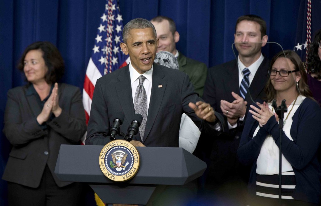 President Barack Obama speaks in the South Court Auditorium of the Eisenhower Executive Office Building on the White House complex in Washington, Thursday, April 16, 2015, during a Champions of Change event highlighting issues important to working families. Sanding on stage with the president are people that have championed working families. (AP Photo/Carolyn Kaster)