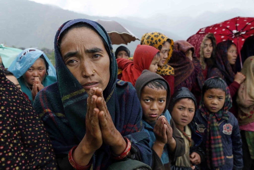 Ramaya pleads for food after an aid relief helicopter lands at the remote mountain village of Gumda, near the epicenter of Saturday's massive earthquake in the Gorkha District of Nepal, Wednesday, April 29, 2015. Aid reached the hilly district for the first time Wednesday, four days after the quake struck. (AP Photo/Wally Santana)