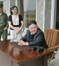 North Korean leader Kim Jong Un (seated) and his wife Ri Sol Jul look on during a visit to Unit 1017 of the Korean People's Army. (KCNA/Yonhap)