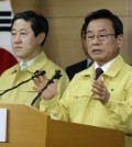 South Korean Public Safety and Security Minister Park In-yong, right, speaks during a press conference as Oceans and Fisheries Minister Minister Yoo Ki-june listens at the government complex in Seoul, South Korea, Wednesday, April 22, 2015. South Korea on Wednesday formally approved plans to salvage the ferry Sewol that sank last year, meeting demands made by bereaved families wanting details about the cause of the sinking and the recovery of bodies of nine people still missing. The disaster killed more than 300 people, mostly high school students on a trip to a resort island. (AP Photo/Ahn Young-joon)