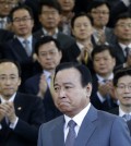 South Korean Prime Minister Lee Wan Koo, bottom center, leaves the Central Government Complex after his farewell ceremony in Seoul, South Korea Monday, April 27, 2015. South Korean President Park Geun-hye on Monday accepted the resignation offer by her prime minister over a bribery scandal. (AP Photo/Ahn Young-joon)