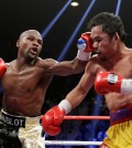 Floyd Mayweather Jr., left, hits Manny Pacquiao, from the Philippines, during their welterweight title fight on Saturday, May 2, 2015 in Las Vegas. (AP Photo/Isaac Brekken)