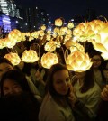 Buddhist believers holding lanterns in the shape of lotus flowers walk around the Gwanghwamun Plaza to celebrate upcoming Buddha's birthday on May 25 in Seoul, South Korea. (AP Photo/Ahn Young-joon)