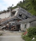 FILE - In this file photo taken July 16, 2014, a man stands near the razed remains of a Catholic church in a village in Pingyang county of Wenzhou in eastern China's Zhejiang province. The Chinese province where authorities have forcibly removed hundreds of rooftop crosses from Protestant and Catholic churches has proposed a ban on any further placement of the religious symbol atop sanctuaries. (AP Photo/Didi Tang, File)