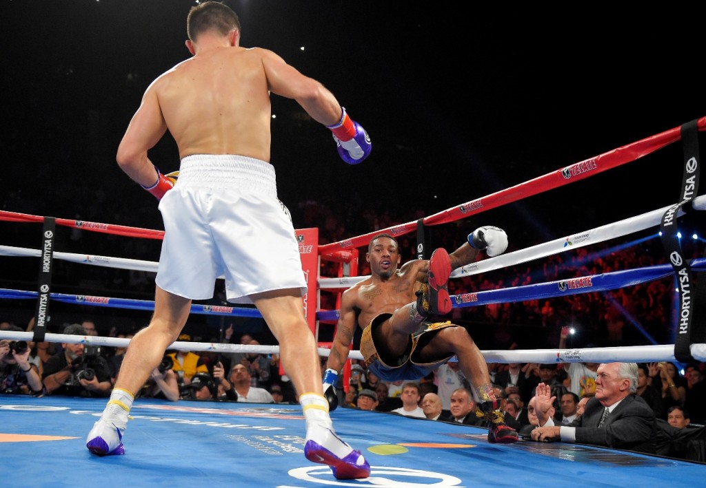 Willie Monroe, Jr., right, is knocked down by Gennady Golovkin, of Kazakhstan, during the second round of a boxing bout, Saturday, May 16, 2015, in Inglewood, Calif. (AP Photo/Mark J. Terrill)
