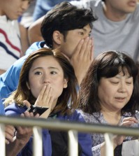 Japanese soccer fans react to a strong earthquake as they watch a J-League soccer match between the Shonan Bellmare and the Sanfrecce Hiroshima at BMW Stadium in Hiratsuka, southwest of Tokyo Saturday, May 30, 2015. A powerful and extremely deep earthquake struck a group of remote Japanese islands and shook Tokyo on Saturday, but officials said there was no danger of a tsunami, and no injuries or damage were immediately reported. (Munehide Someya/Kyodo News via AP)