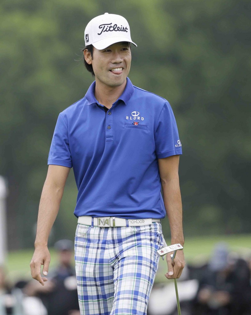 Kevin Na carries a putter after sinking his shot on the ninth hole during the second round of the Colonial golf tournament, Friday, May 22, 2015, in Fort Worth, Texas. (AP Photo/LM Otero)