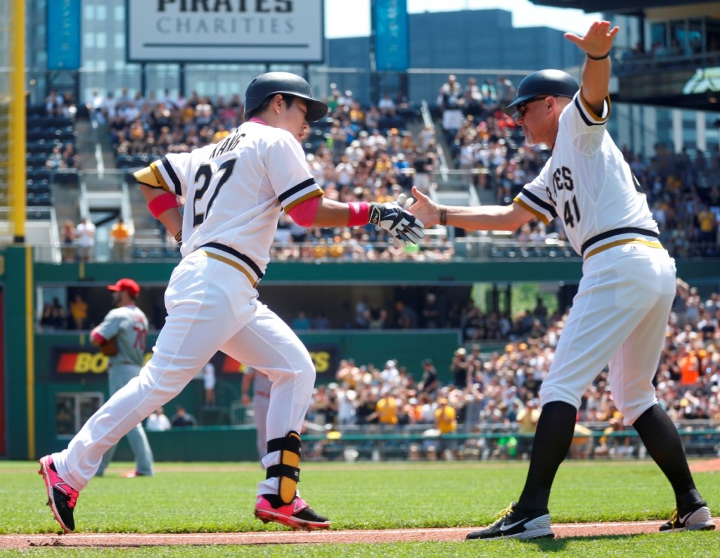 Pittsburgh Pirates' Jung Ho Kang (27) is greeted by third base coach Rick Sofield (41) after hitting a solo home run off St. Louis Cardinals starting pitcher Tyler Lyons, background left, in the first inning of a baseball game, Sunday, May 10, 2015, in Pittsburgh. (AP Photo/Keith Srakocic)