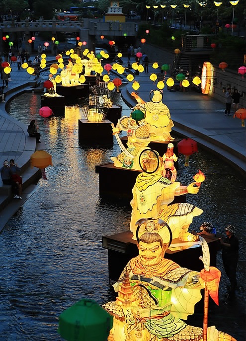People enjoy looking at colorful lotus lanterns lit along the Cheonggye Stream in Seoul on May 13, 2015, ahead of Buddha's Birthday, which falls on May 25. (Yonhap) 