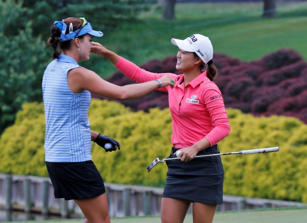 Minjee Lee, of Australia, right, hugs fellow golfer, Lexi Thompson, left, on the 18th hole of the rain delayed Kingsmill Championship LPGA golf tournament at the Kingsmill Golf Club in Williamsburg, Va., Monday, May 18, 2015. Lee won the tournament. (AP Photo/Steve Helber)