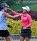 Minjee Lee, of Australia, right, hugs fellow golfer, Lexi Thompson, left, on the 18th hole of the rain delayed Kingsmill Championship LPGA golf tournament at the Kingsmill Golf Club in Williamsburg, Va., Monday, May 18, 2015. Lee won the tournament. (AP Photo/Steve Helber)