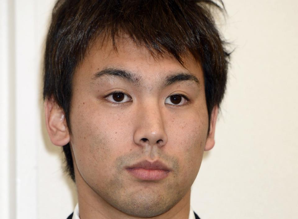 Japanese swimmer Naoya Tomita, who was suspended for stealing a camera at the Asian Games, attends a news conference in Nagaya, central Japan, Thursday, Nov. 6, 2014. Tomita has denied the allegations, claiming someone placed the camera in his gym bag. He initially admitted to stealing a camera left poolside by a South Korean reporter on Sept. 25 at the games in Incheon, South Korea. (AP Photo/Kyodo News)