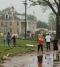 Dozens of Van, Texas, residents walk around the intermediate and elementary schools campuses as they survey the damage from Monday, May 11, 2015 severe weather that moved through the area in the early morning hours. Emergency responders searched through splintered wreckage Monday after a line of tornadoes battered several small communities in Texas and Arkansas, killing at least five people. (AP Photos/Todd Yates)