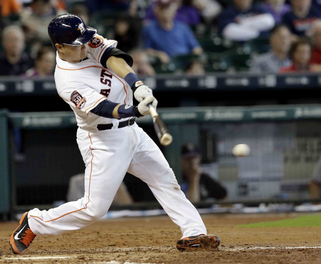 Houston Astros' Hank Conger hits an RBI single against the Colorado Rockies in the third inning of a baseball game Tuesday, June 16, 2015, in Houston. (AP Photo/Pat Sullivan)