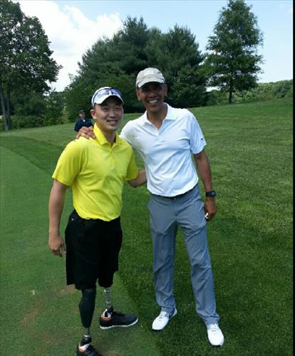 Jason Pak, left, and President Barack Obama at TPC Potomac golf club Saturday.