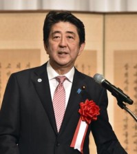 Japanese Prime Minister Shinzo Abe delivers a speech at a ceremony to mark the 50th anniversary of normalizing relations between Japan and South Korea, hosted by South Korean Embassy in Tokyo Monday, June 22, 2015. South Korean Foreign Minister Yun Byung-se attended the ceremony. (Yoshikazu Tsuno/Pool Photo via AP)