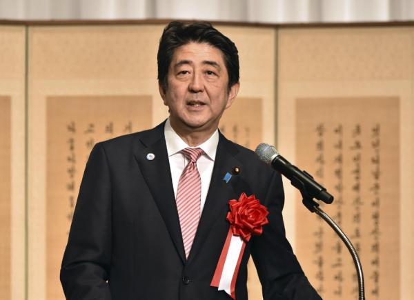 Japanese Prime Minister Shinzo Abe delivers a speech at a ceremony to mark the 50th anniversary of normalizing relations between Japan and South Korea, hosted by South Korean Embassy in Tokyo Monday, June 22, 2015. South Korean Foreign Minister Yun Byung-se attended the ceremony. (Yoshikazu Tsuno/Pool Photo via AP)
