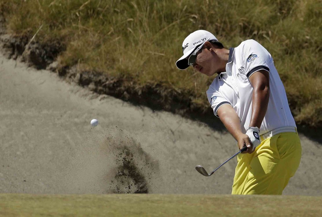 An Byeong-hun, of South Korea, hits out of the bunker on the 18th hole during a practice round for the U.S. Open golf tournament at Chambers Bay on Wednesday, June 17, 2015 in University Place, Wash. (AP Photo/Charlie Riedel)