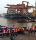 Rescue workers prepare to head out on boats on the Yangtze River to search for missing passengers after a ship capsized in central China's Hubei province Tuesday, June 2, 2015. The passenger ship carrying more than 450 people sank overnight in the Yangtze River during a storm in southern China, the official Xinhua News Agency reported Tuesday. (Chinatopix Via AP)